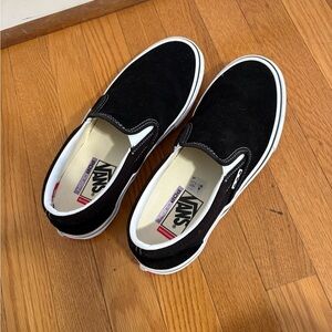 Vans women’s Black and White Slip-On Sneakers